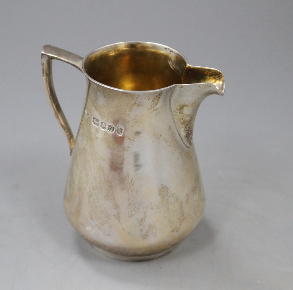 A 1970s silver cream jug by Brian Leslie Fuller, London, 1977, height 92mm, 5.5 oz.